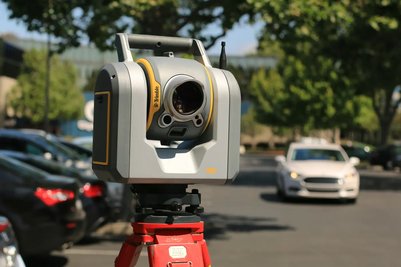 A total station set up on a tripod at a job site